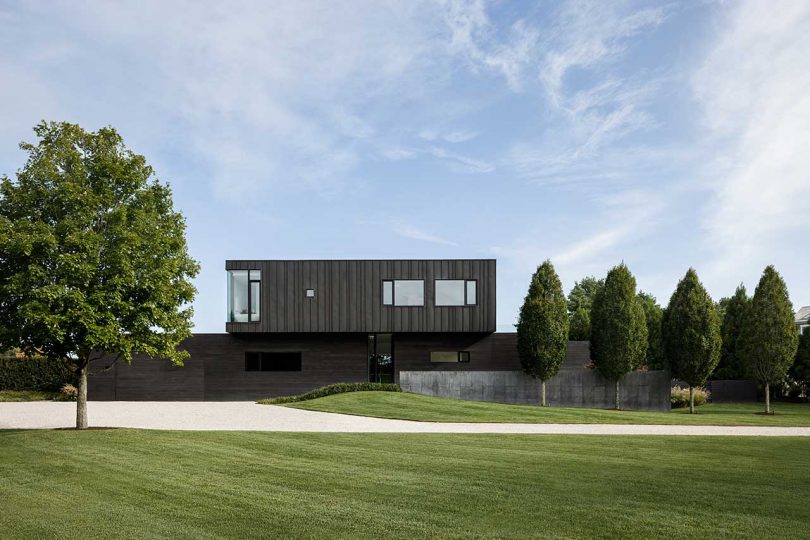 daytime exterior shot of modern two-story black house