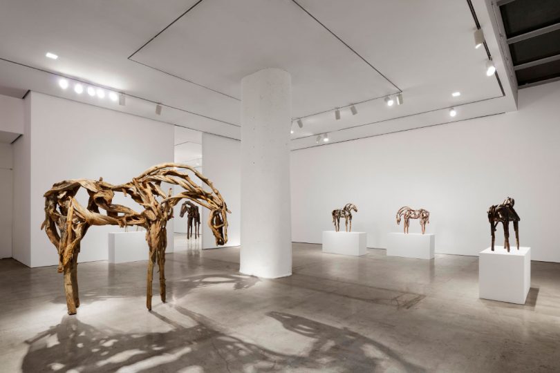 Main room of gallery exhibition with large "Sweetgrass" and smaller sculptures