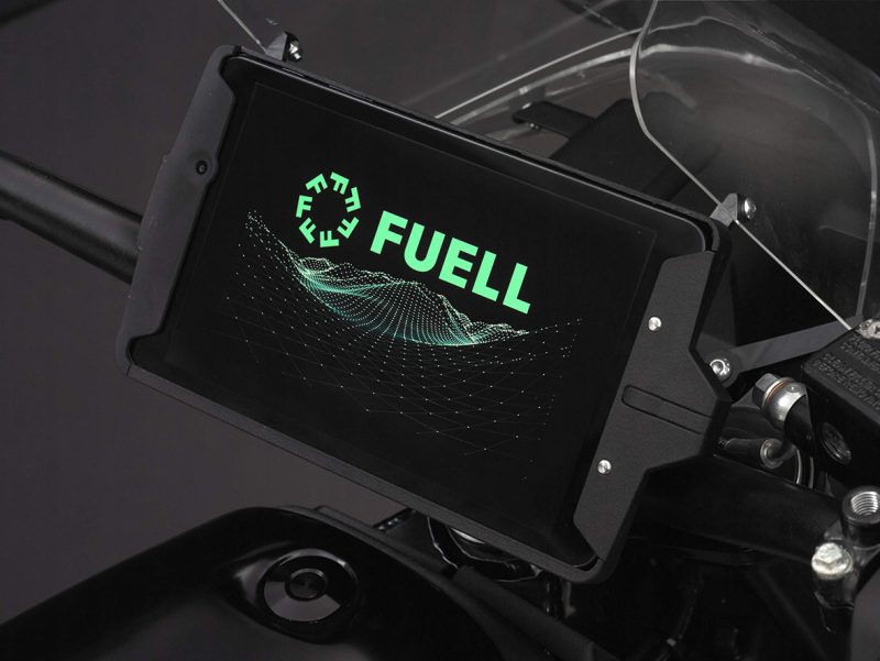 FUELL electric motorcycle digital display with green FUELL logo on screen.