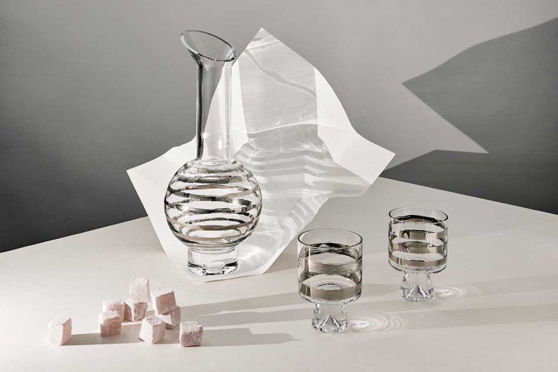 glass and silver decanter and two matching glasses