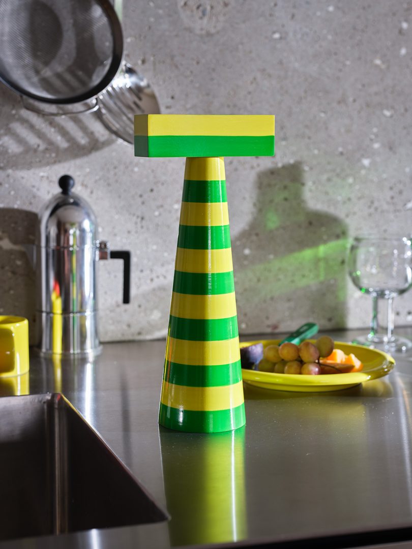 a colorful striped salt or pepper grinder on a kitchen counter
