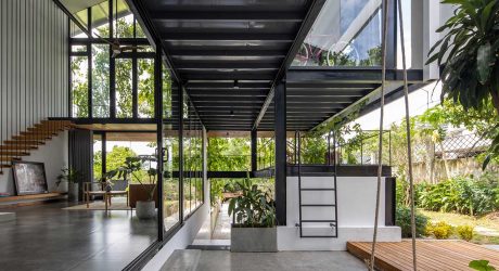 A Glass-Stacked House in Vietnam Shrouded in Greenery