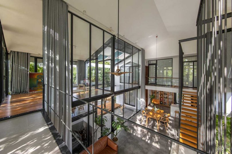 second floor interior shot of modern home with glass walls looking through interior