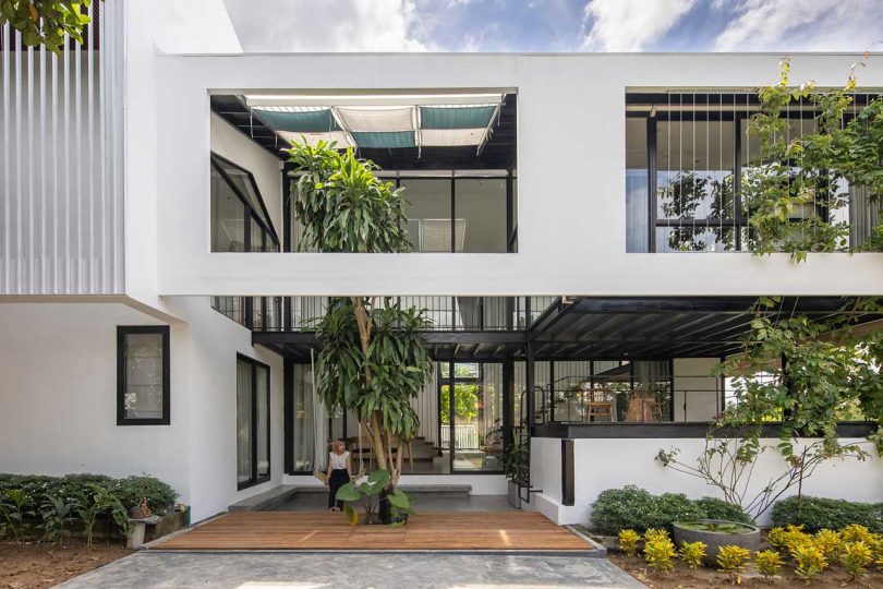 exterior shot of modern white monolithic house with cutouts