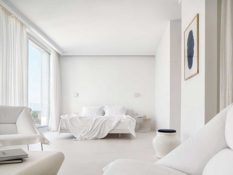 bedroom of minimalist all-white modern house