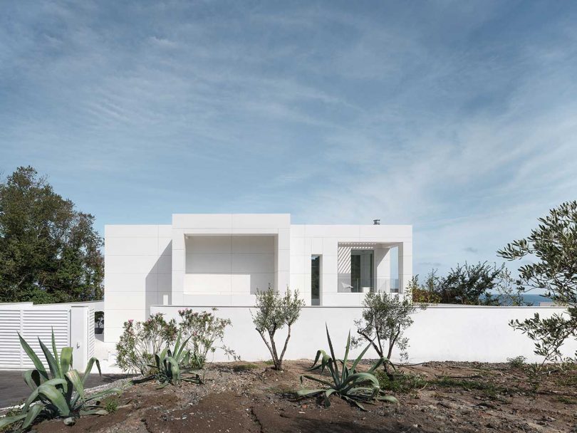 exterior view of minimalist, all-white modern house