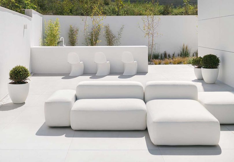 minimalist exterior of modern white house with exterior seating