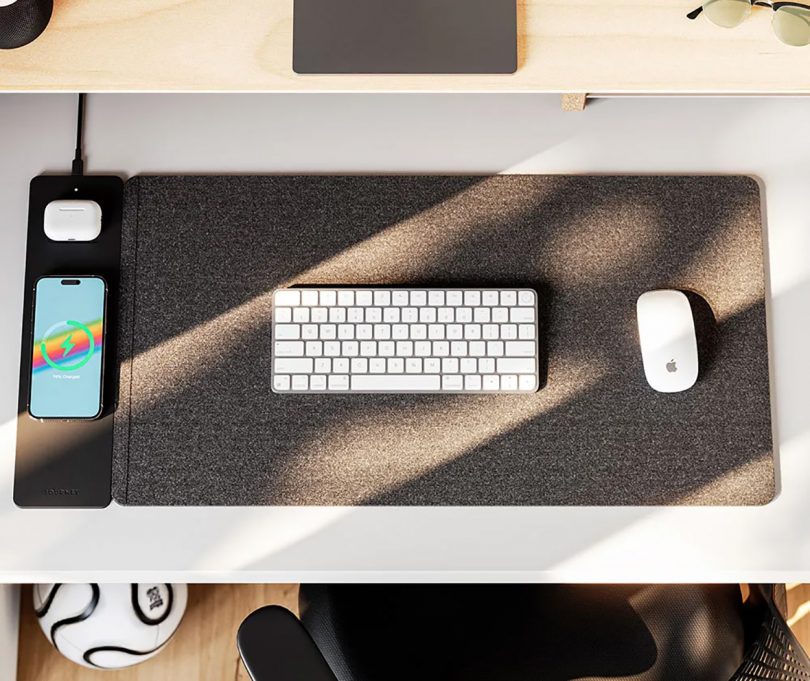 Felt ALTI desk mat with iPhone and AirPods charging wirelessly next to all-white Apple keyboard and Magic Mouse.