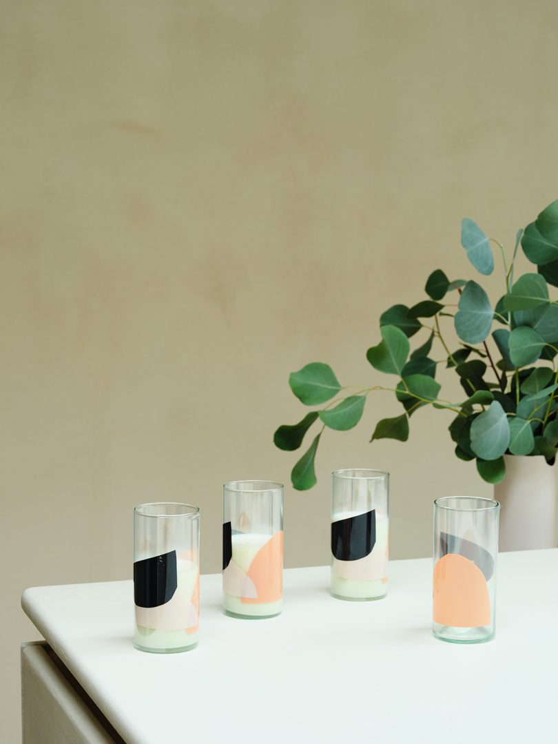 table styled with abstract patterned glassware and greenery in a planter