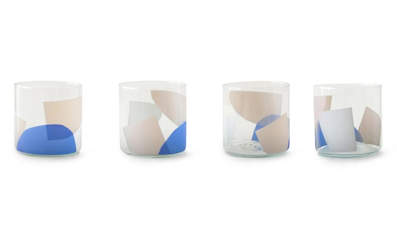 four abstract tumbler glasses on white background