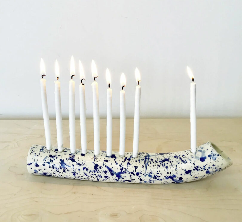 blue and white splatter ceramic tube-like menorah