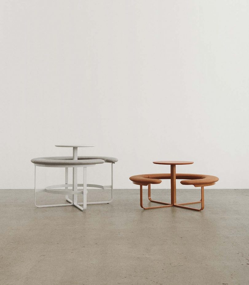 two circular tables surrounded by attached circular benches