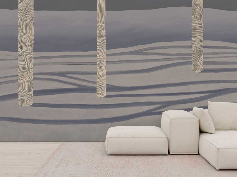 wall with dramatic landscape wallpaper and white sofa