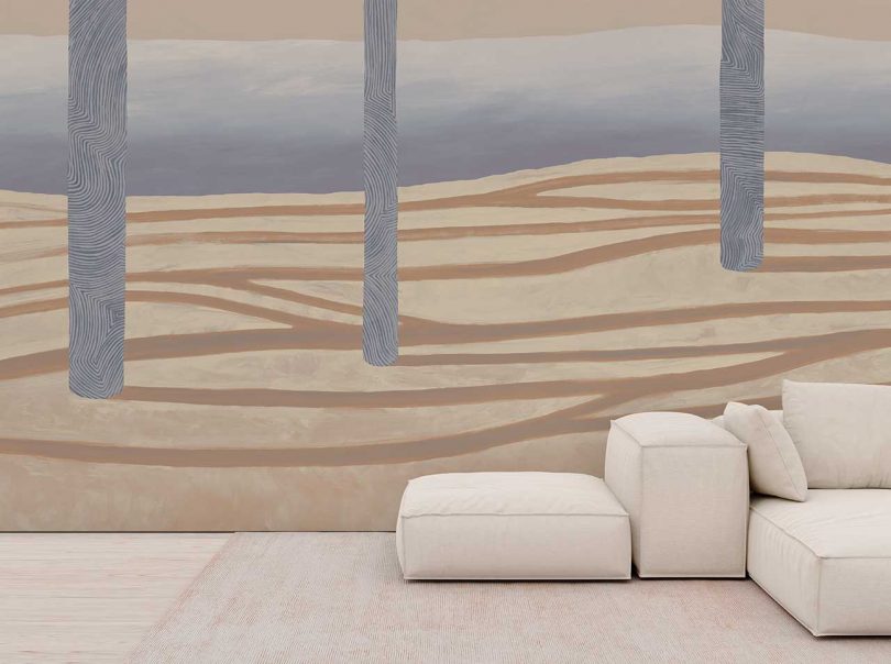 wall with dramatic landscape wallpaper and white sofa