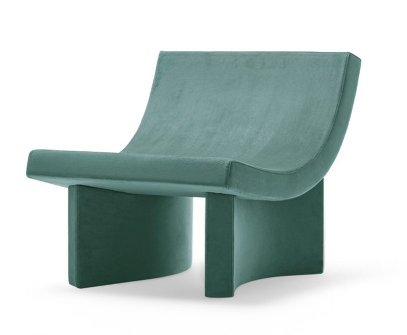 curved teal lounge chair on white background