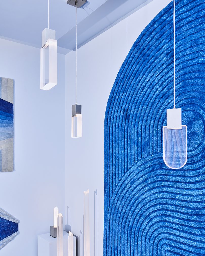blue wall and hanging pendant lights at a blue-themed exhibition