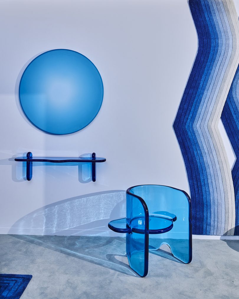 blue shelf, armchair, and wall art at a blue-themed exhibition