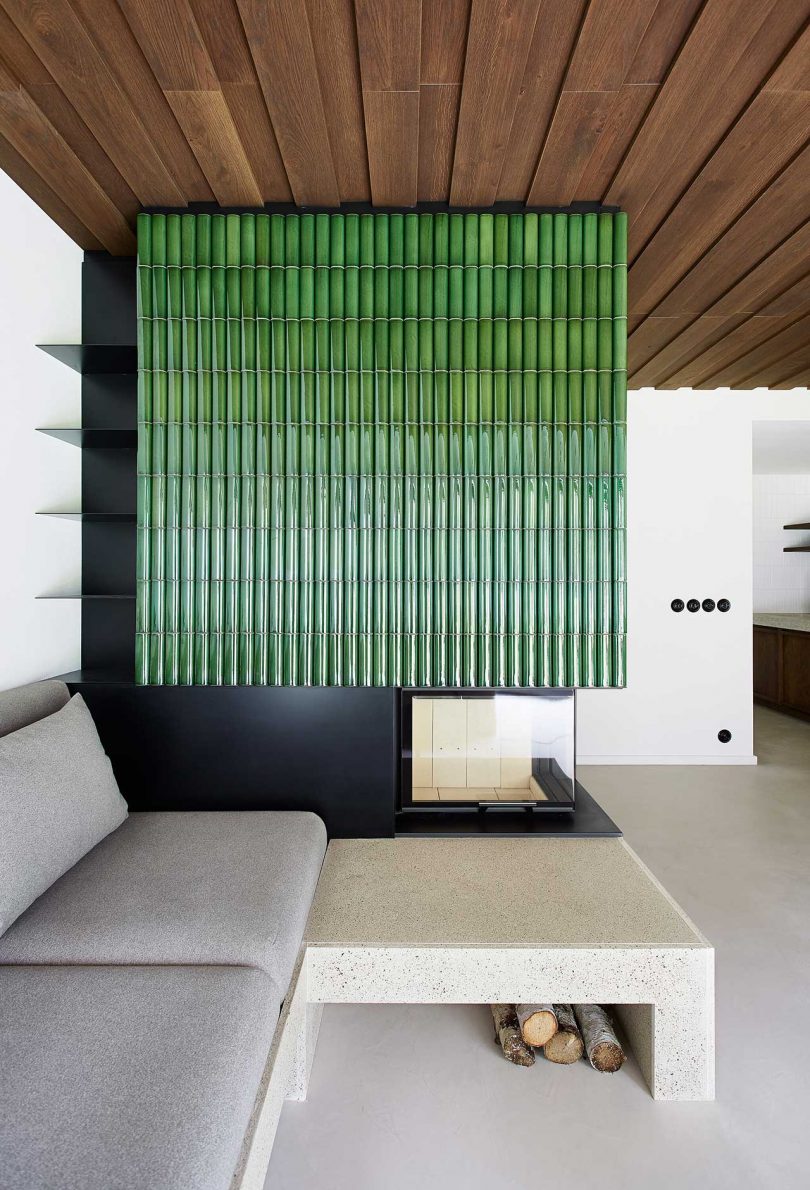 A Weekend Apartment With a Dramatic, Green Tiled Fireplace in the Mountains