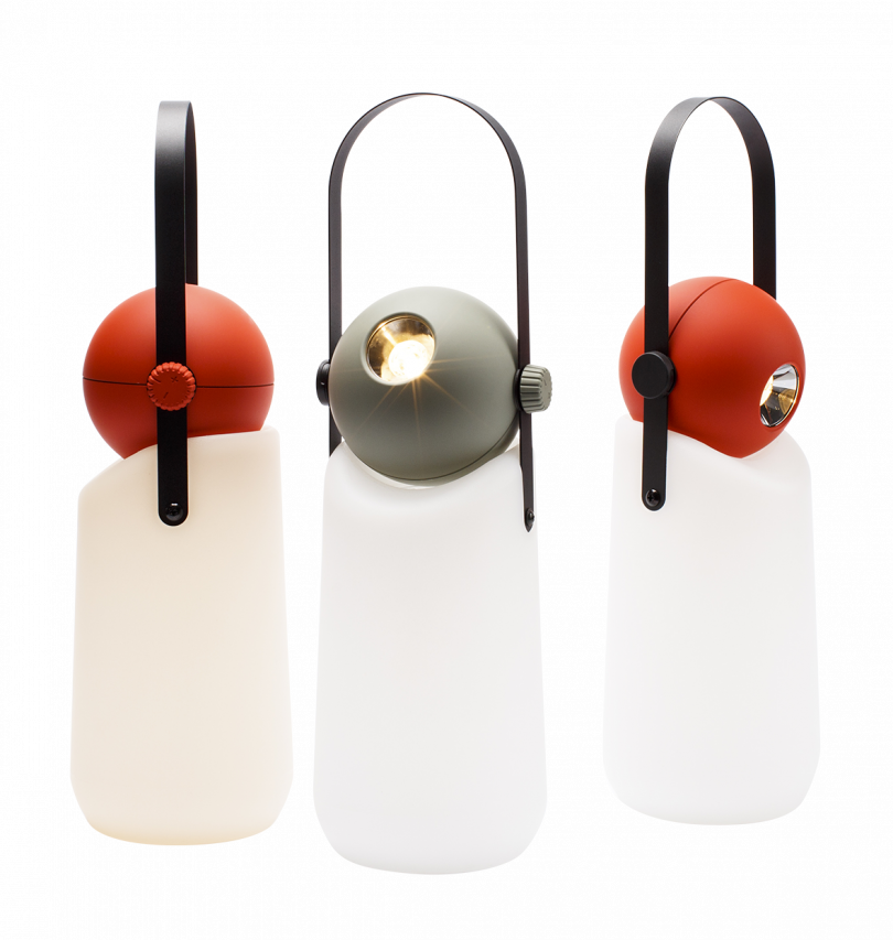 three portable lamps with a white bases, red and grey tops, and black strap handles on a white background