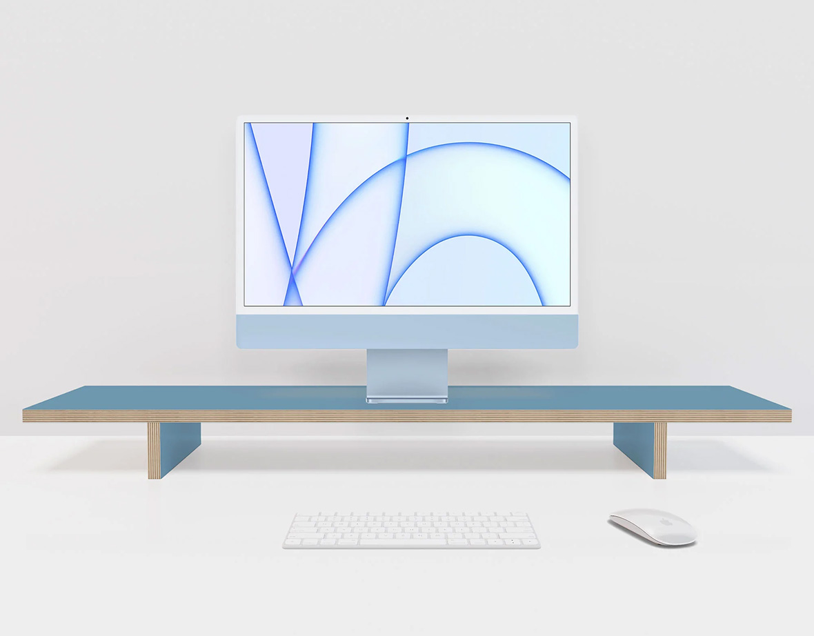 Compustands Simple Monitor Stand in blue with iMac on top with Apple keyboard and mouse.