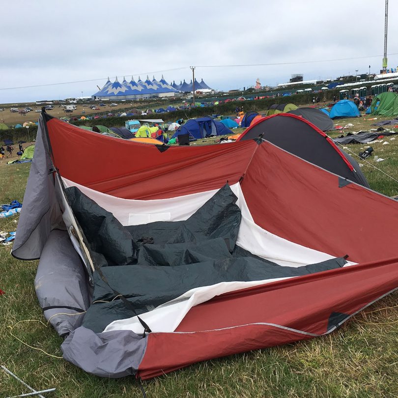 broken tent with field of discarded tents around it
