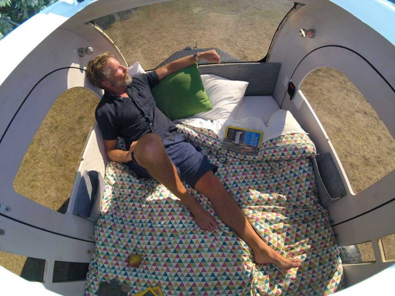 down view of an relaxing in a teardrop camper