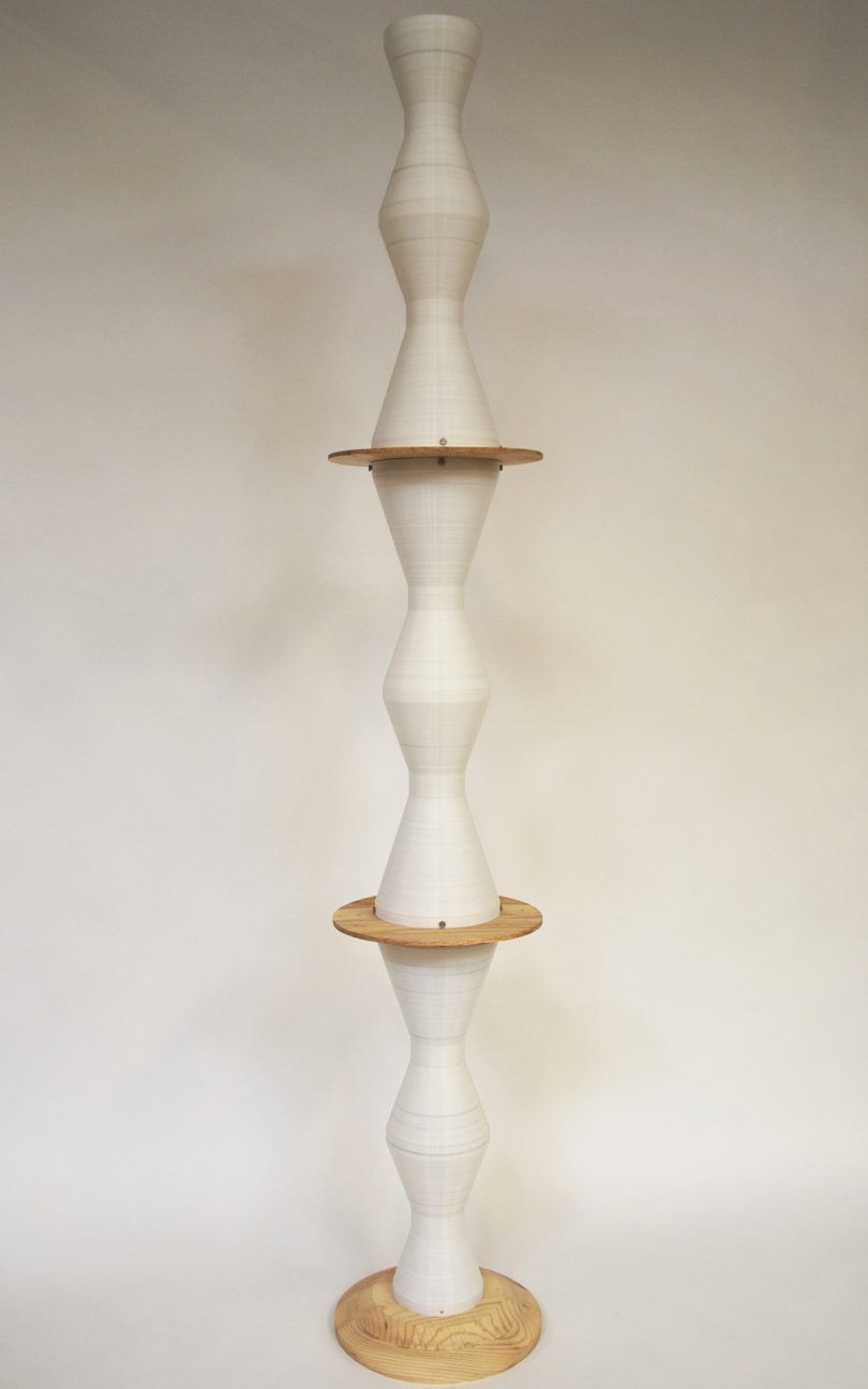 curvaceous while column punctuated by wooden disks