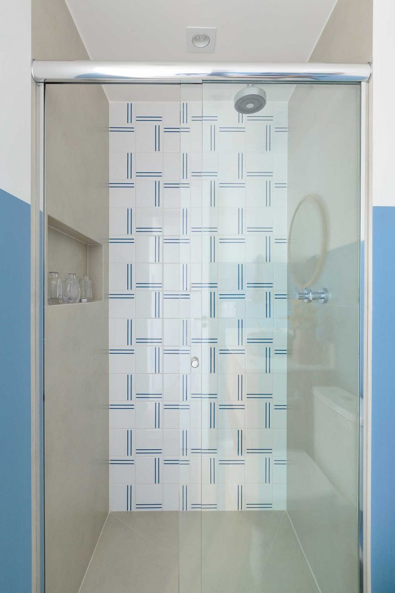 view into modern shower with modern white and blue tile pattern