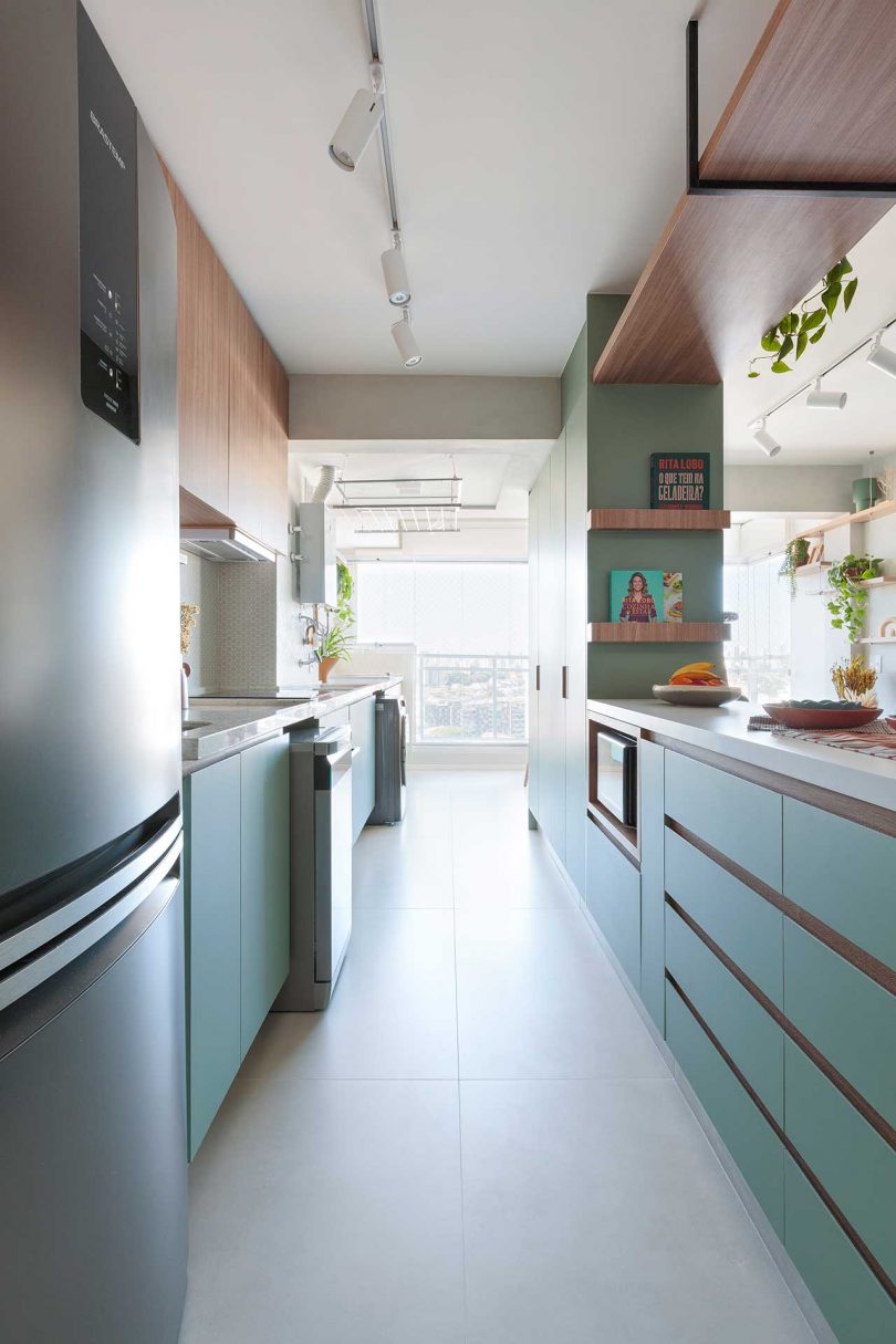 view of green galley kitchen in modern apartment