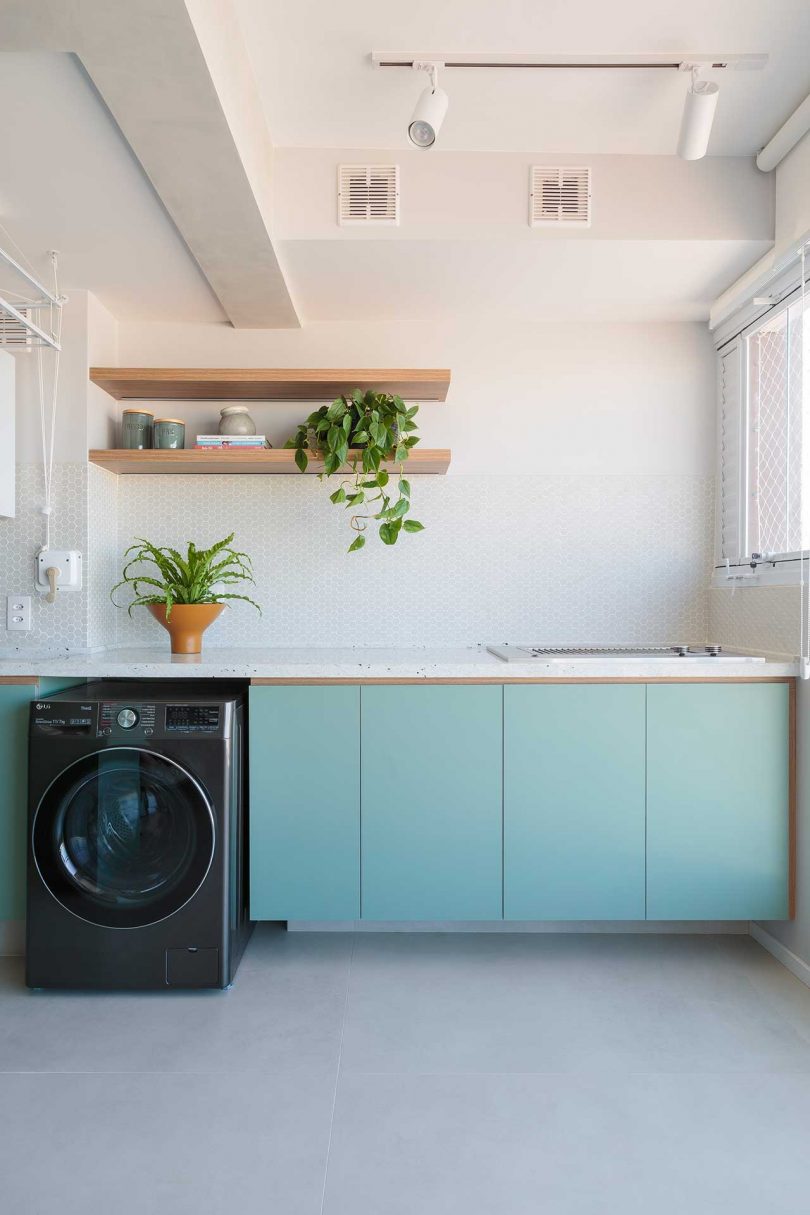 view of green cabinets with washer built in