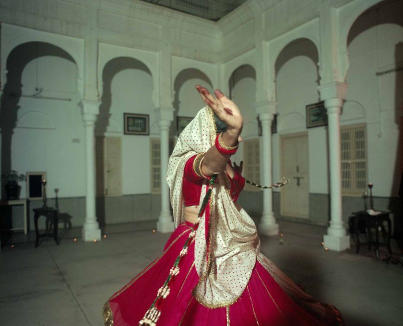 Indian woman in red and white dress dancing