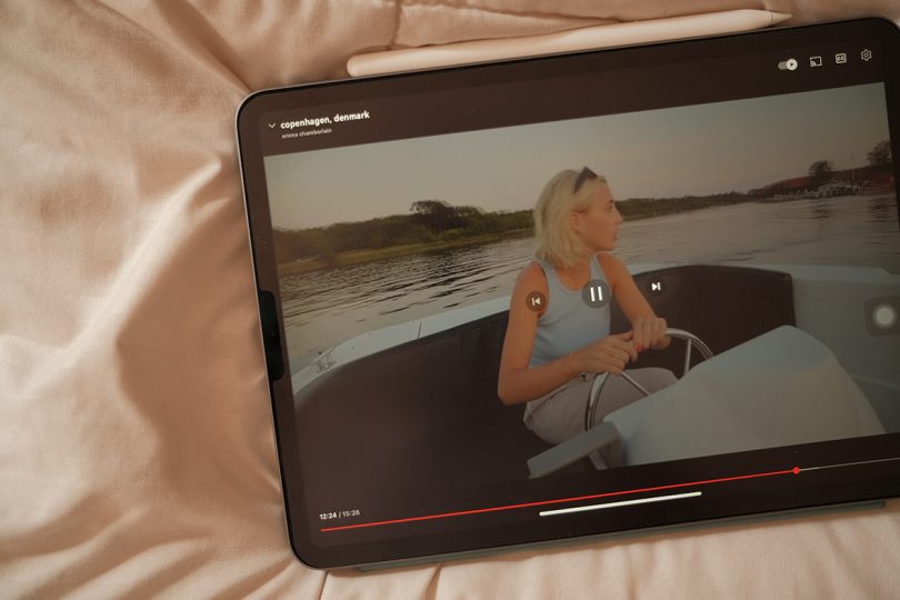 digital tablet screen with a paused video of a woman