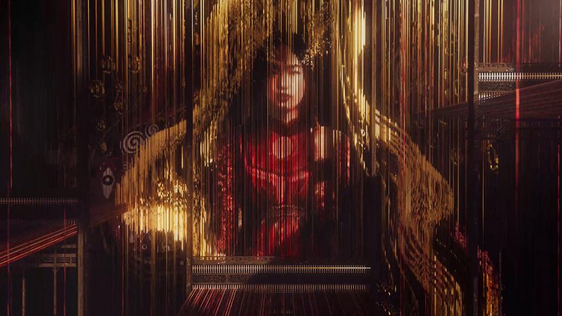 a woman wearing red behind a curtain