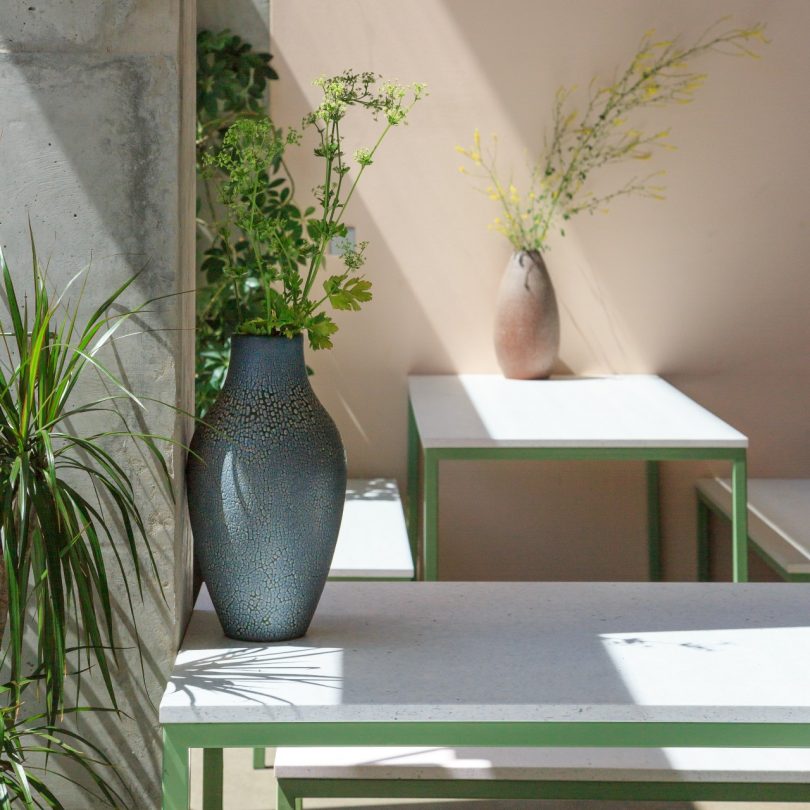 view o multiple green tables with white terrazzo like surfaces