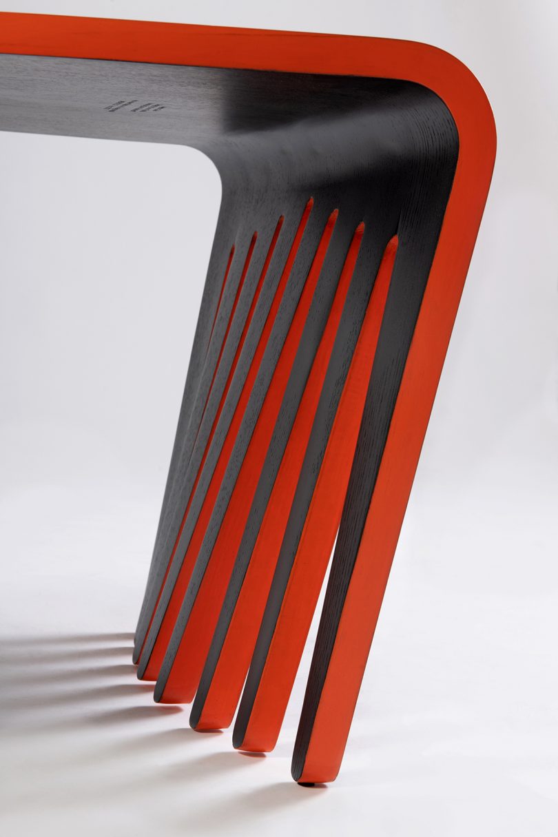 detail of black and orange chair that resembles and Afro Comb