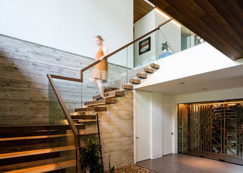 modern home interior with double height ceiling and open staircase