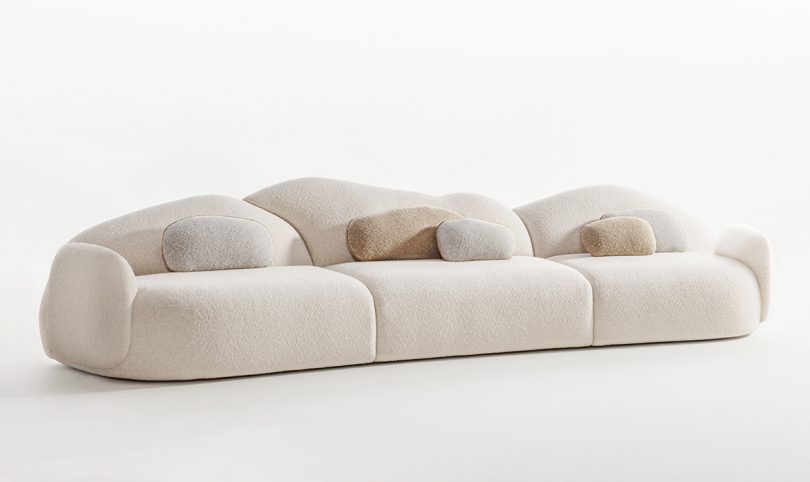 large sofa with a curving back upholstered in white