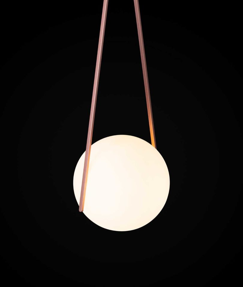 suspended pendent light orb on black background