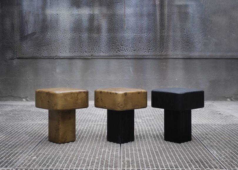 three wood stools in various colors