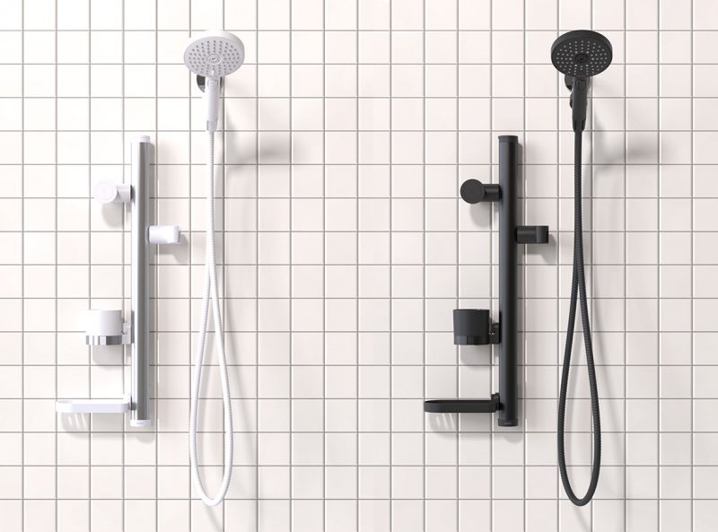 White and black editions of Sproos showerhead against white tiles.