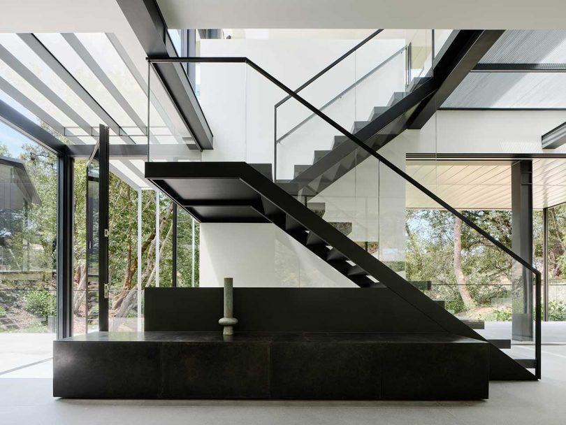 interior view of modern, minimalist house with black and white open staircase