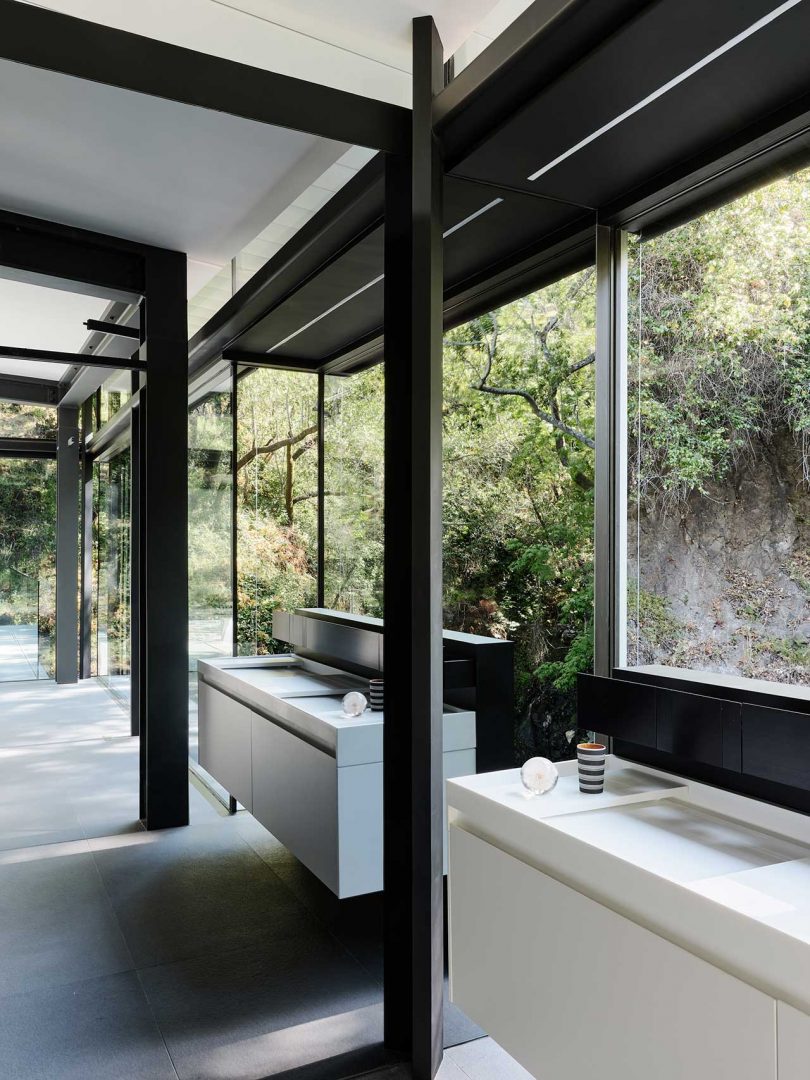 interior view of modern home with minimalsit bathroom with double sinks with windows instead of mirrors