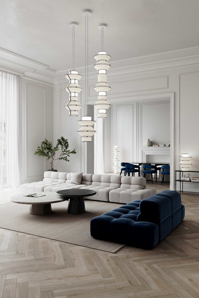 three column-shaped lighting pendants in styled living space