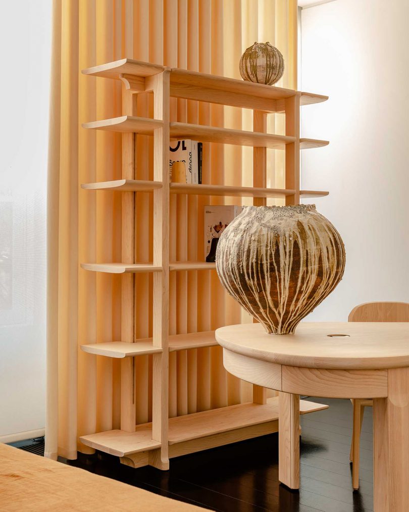 styled interior space with wood desk, chair, and shelving