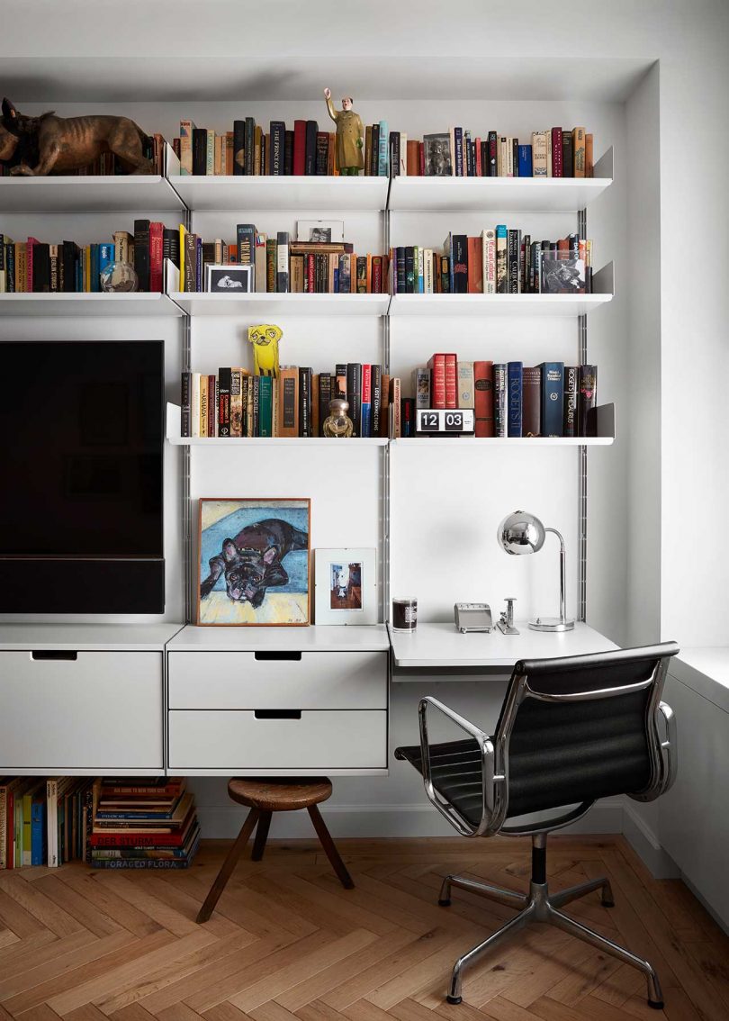 view of home office featuring wall-mounted desk and shelving system