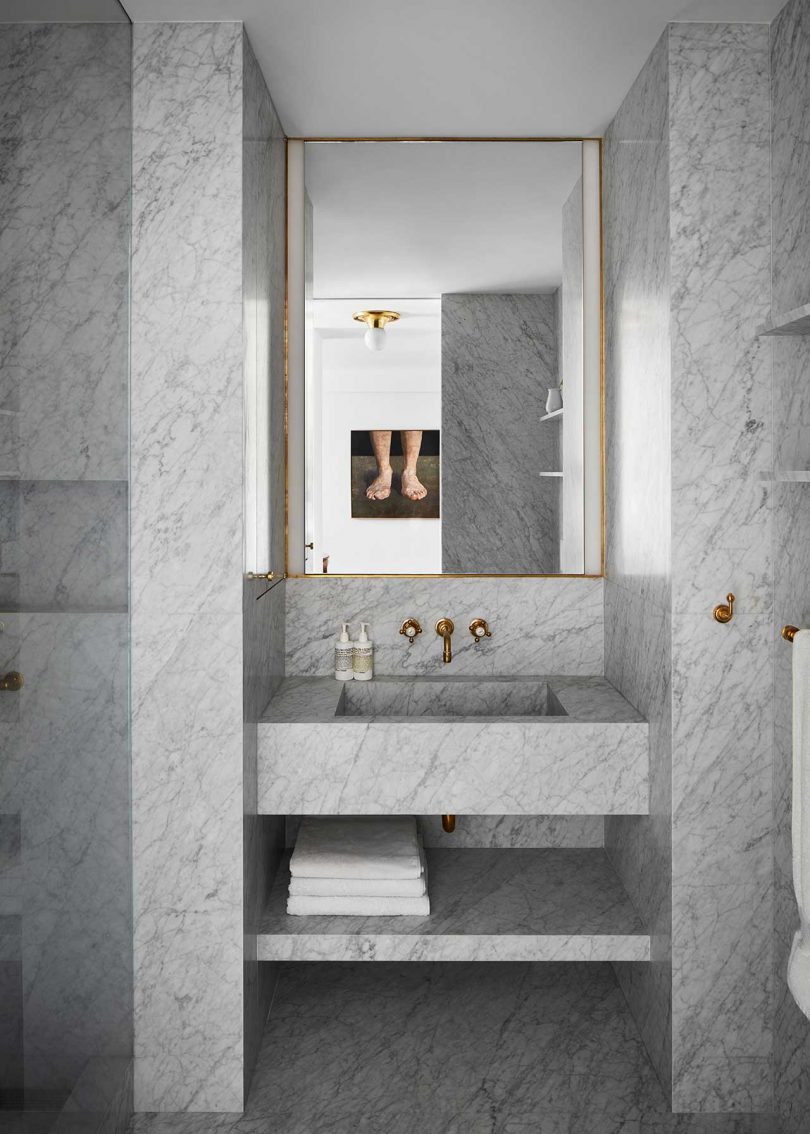 modern bathroom with white and gray marble surfaces 