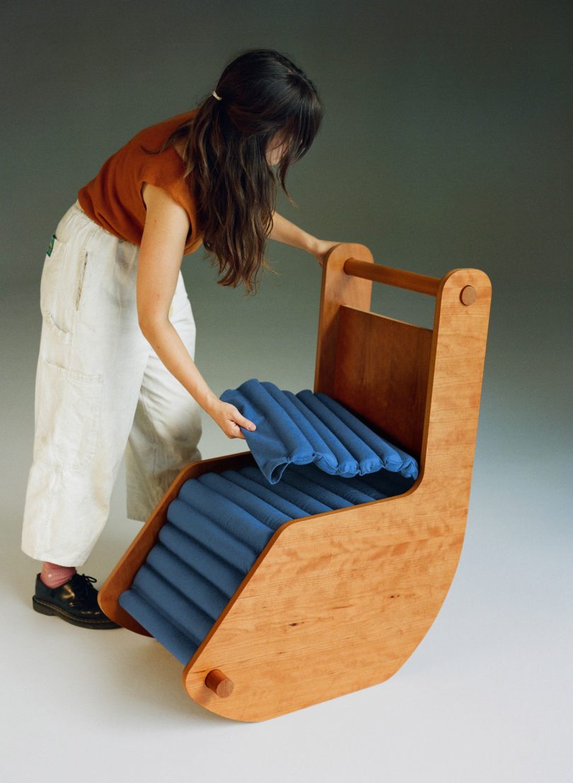 women putting blue cushion on reading chair