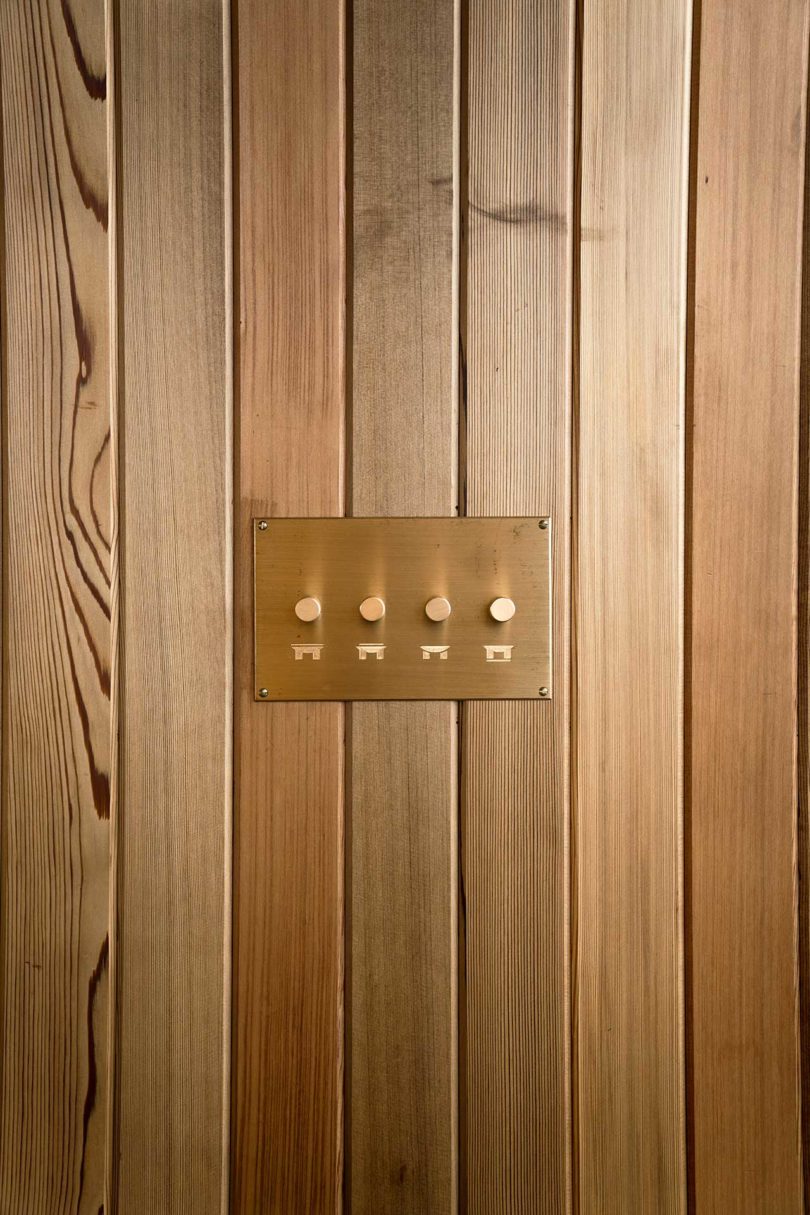 closeup of light switches in interior of modern wooden floating sauna on water
