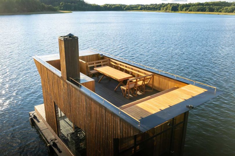 angled above view of modern wooden floating sauna on water