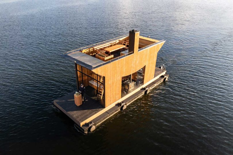 angle above view of modern wooden floating sauna on water